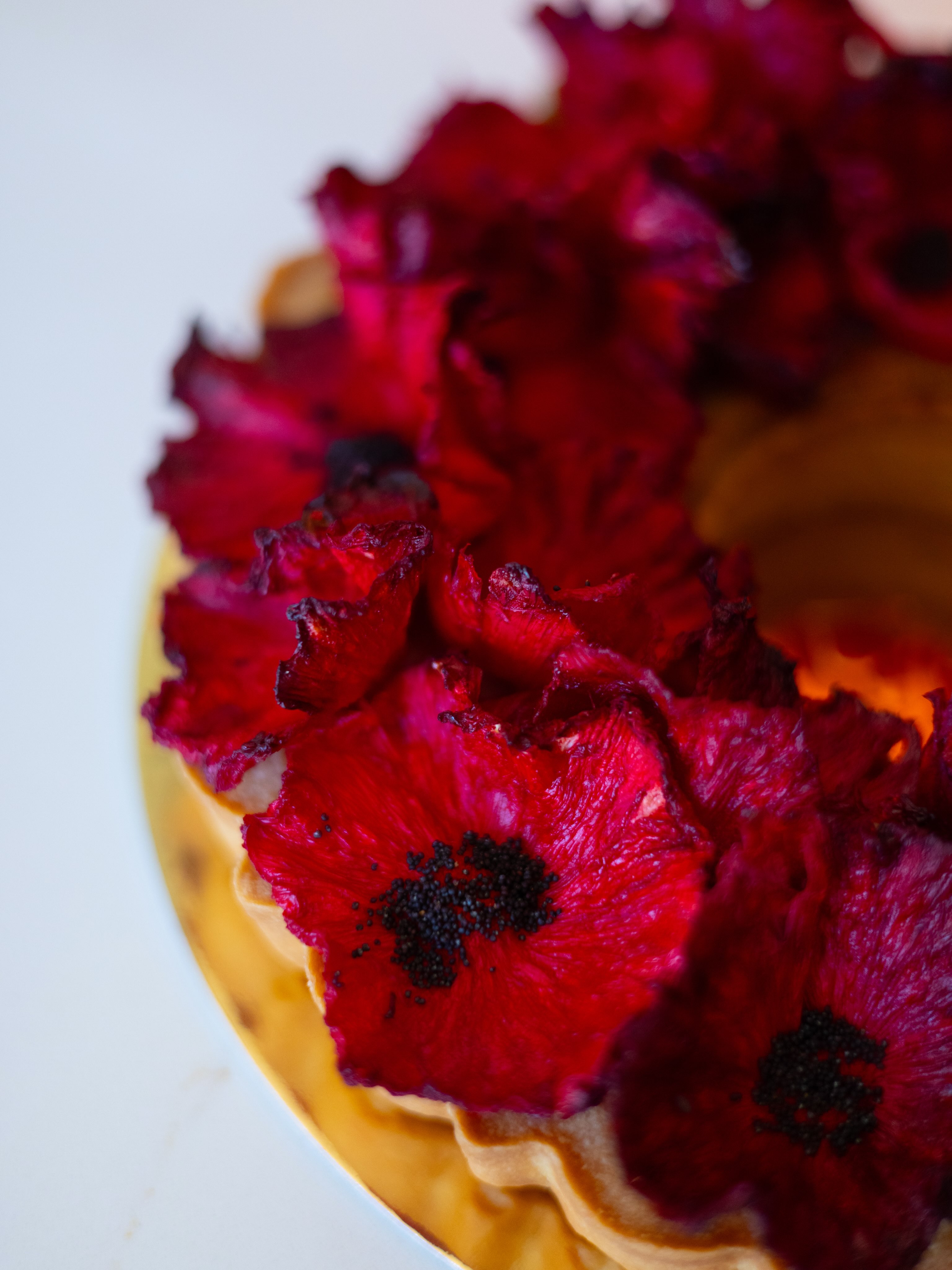 Deep red flower-shaped pastries by Karamel Artisanal Bakery