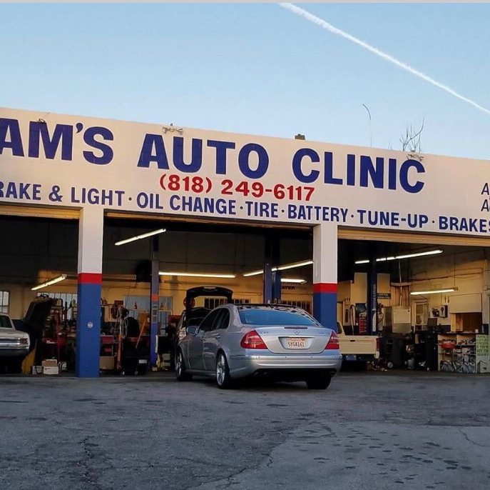 A vehicle being serviced inside Sam's Auto Clinic